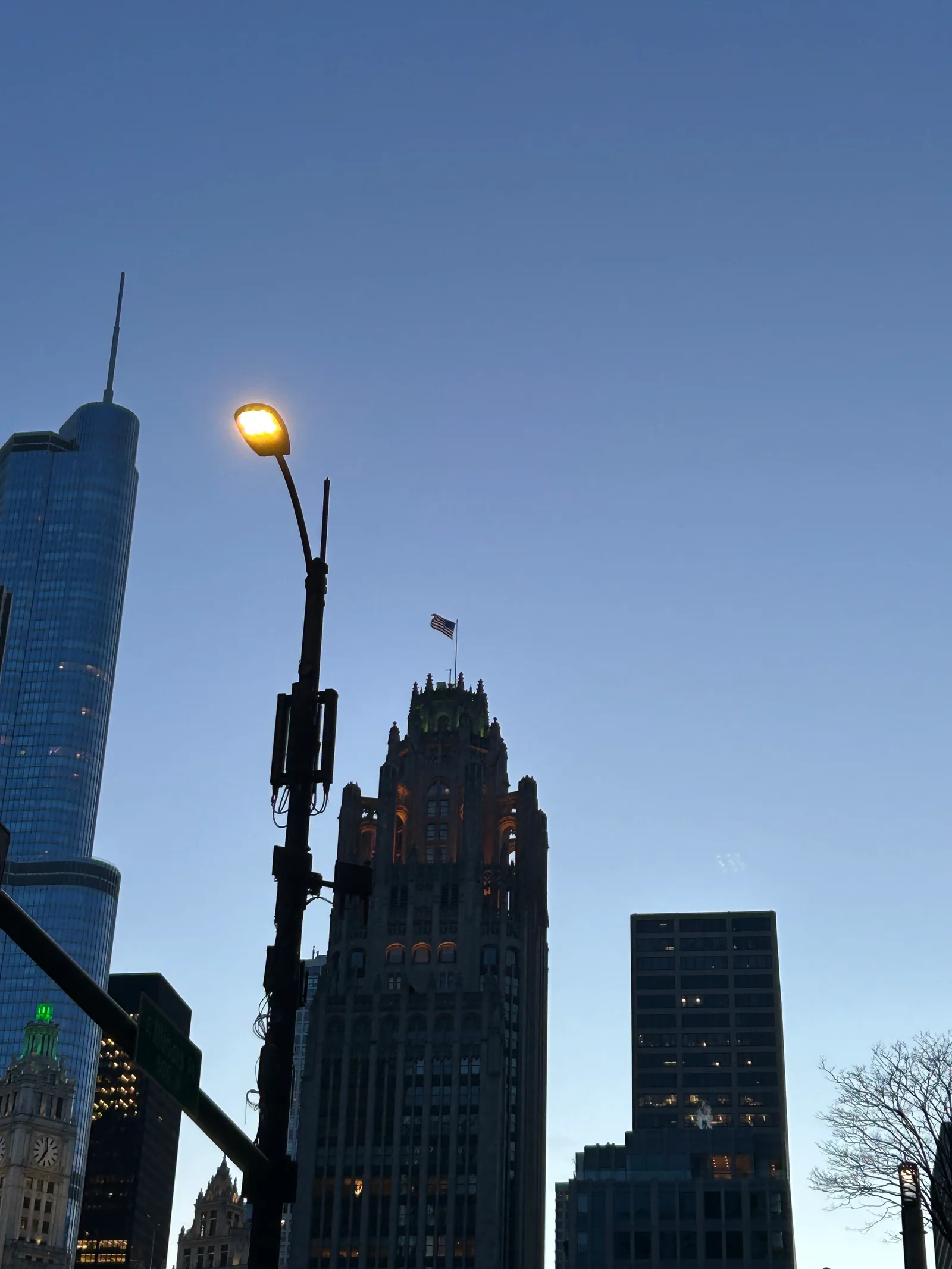 Downtown Chicago buildings beneath a deep blue evening sky.